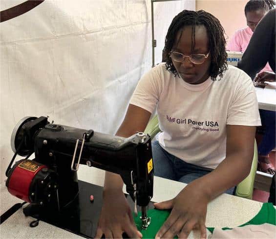 Marion from Girl Power USA stitching a pad at the Together for Better workshop