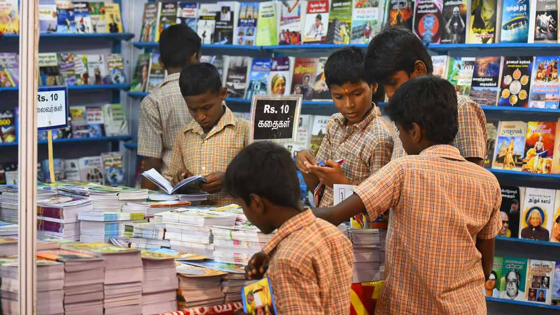 Kids reading books at a bookstore - Education in India 