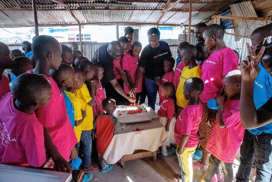 Girl-Power-USA-volunteers-cutting-a-cake-with-children