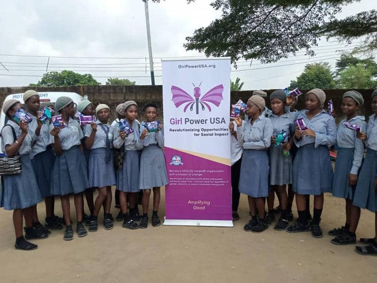 E-enable-girls-posing-to-take-a-picture-beside-Girl-Power-USA-banner.