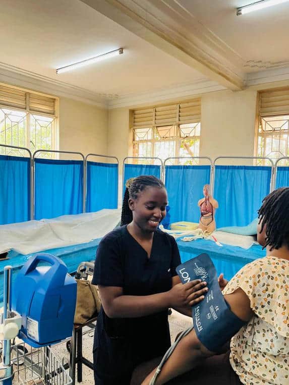 Devota-is-measuring-blood-pressure-for-a-patient.