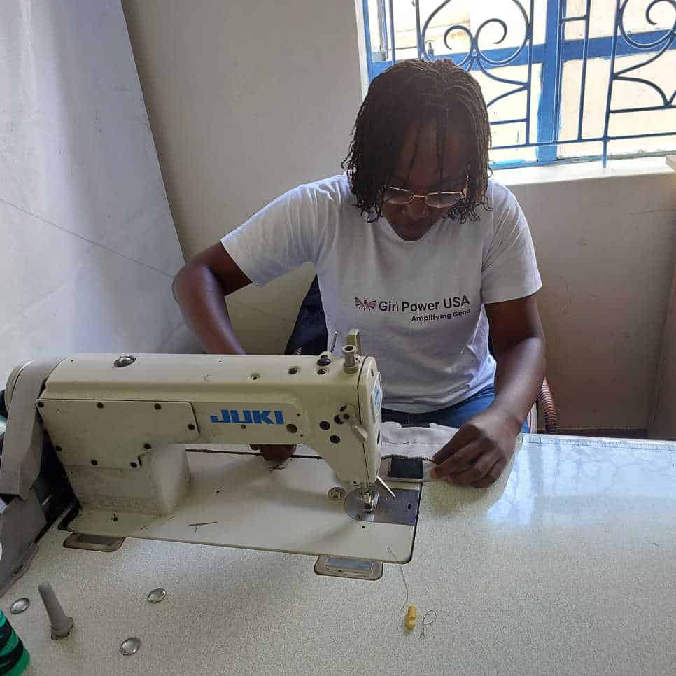 Marion-Nekesa-the-Associate-Director-of-Girl-Power-USA-sewing-a-pad