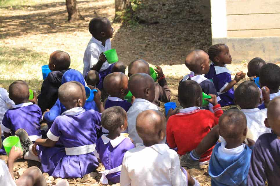 Group-of-children-eating-porridge-at-CYAN-Kenya-community-based project