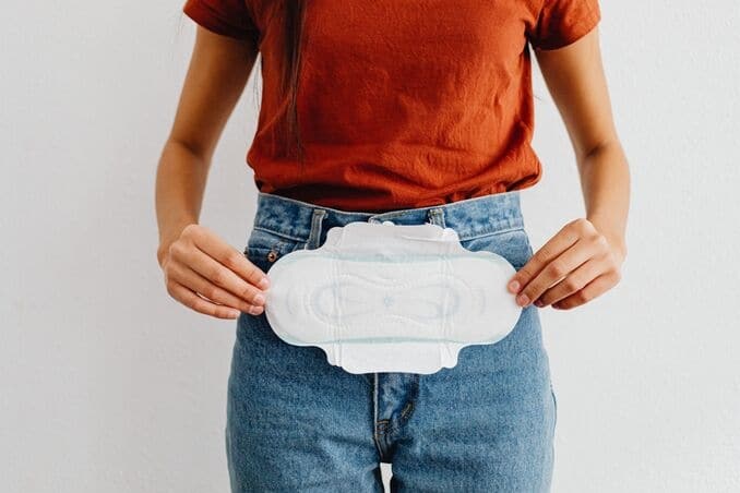 A-woman-showing-a-sanitary-pad-highlighting-menstrual-health-and-hygiene